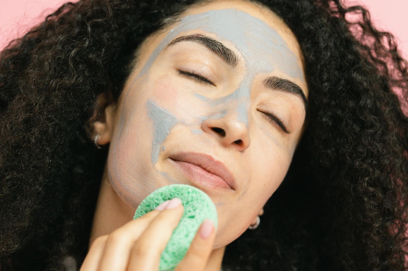 A woman receiving a natural herbal facial treatment